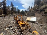 Backhoe buried in post-wildfire washdown